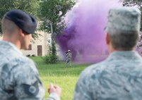 U.S. Air Force Tech. Sgt. Sean McDermott, left, 822d Base Defense Squadron alpha flight squad two leader, walks U.S. Air Force Gen. Hawk Carlisle, commander Air Combat Command, through an exercise scenario demonstrating the different capabilities of the 820th Base Defense Group July 15, 2015, at Moody Air Force Base, Ga. McDermott was also coined by Carlisle for his superior performance. (U.S. Air Force photo by Staff Sgt. Eric Summers Jr./Released)