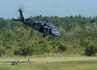 An HH-60G Pavehawk returns to the air after dropping off 38th Rescue Squadron pararescuemen during a combat search and rescue demonstration July 15, 2015, at Moody Air Force Base, Ga. The Pavehawk plays a vital role in the mission of the 23d Wing by conducting day or night personnel recovery operations into hostile environments to recover isolated personnel. (U.S. Air Force photo by Staff Sgt. Eric Summers Jr./Released)