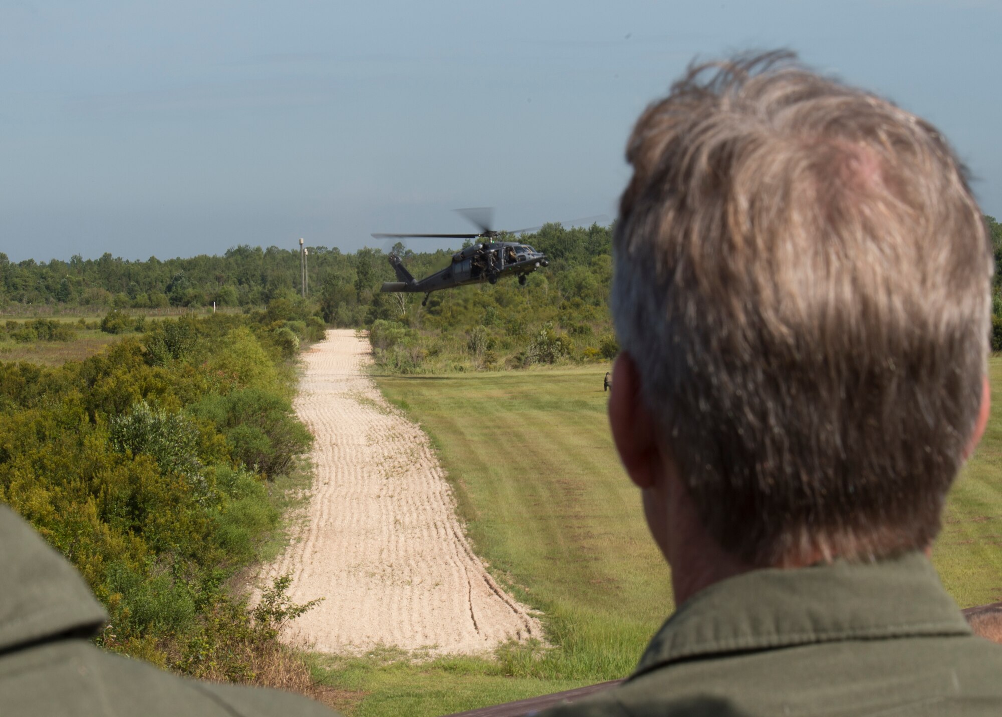 U.S. Air Force Gen. Hawk Carlisle, commander of Air Combat Command, watches as members of the 347th Rescue Group perform an extraction during a display of combat search and rescue demonstration July 15, 2015, at Moody Air Force Base, Ga. The general’s observed the demonstration while visiting Moody Airmen. (U.S. Air Force photo by Staff Sgt. Eric Summers Jr./Released)