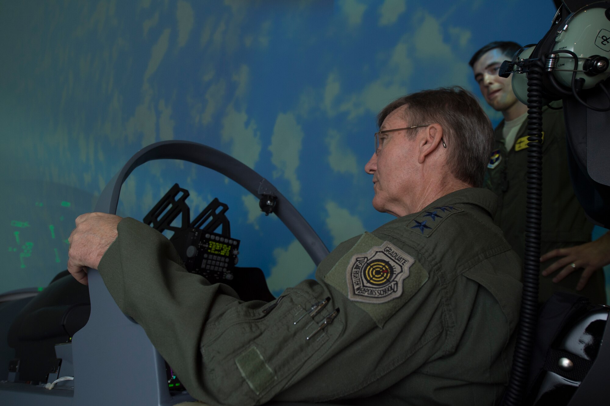 U.S. Air Force Gen. Hawk Carlisle, commander Air Combat Command, pilots the A-29 Super Tucano simulator while a pilot from the 81st Fighter Squadron, provides instructions during his visit July 15, 2015, at Moody Air Force Base, Ga. Carlisle toured various units of the 23d Wing and 93d Air Ground Operations Wing during his two-day visit to Moody. (U.S. Air Force photo by Staff Sgt. Eric Summers Jr./Released)
