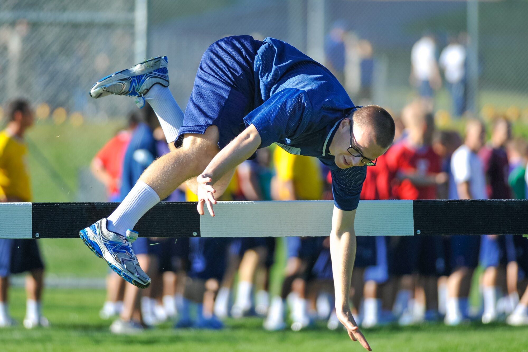 A basic cadet at the U.S. Air Force Academy takes on the high hurtles during Field Day here July 10, 2015. Field Day is an annual competitive event that marks the half-way point through Basic Cadet Training. (U.S. Air Force
photo/Liz Copan)
