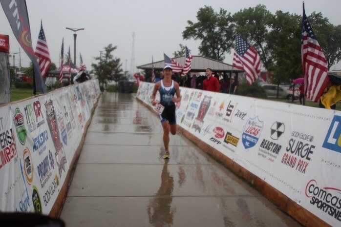 Major Jamie Turner runs toward the finish line during the Armed Forces Triathlon Championship race in Hammond, Indiana, June 7, 2015. Turner continued her world-class triathlete success as the second female to cross the finish line and automatically qualified as one of six athletes to compete on the women’s team at the Military World Games in Mungyeong, South Korea, Oct. 2-11, 2015. Turner is a C-17 pilot with the 317th Airlift Squadron. (Courtesy photo)