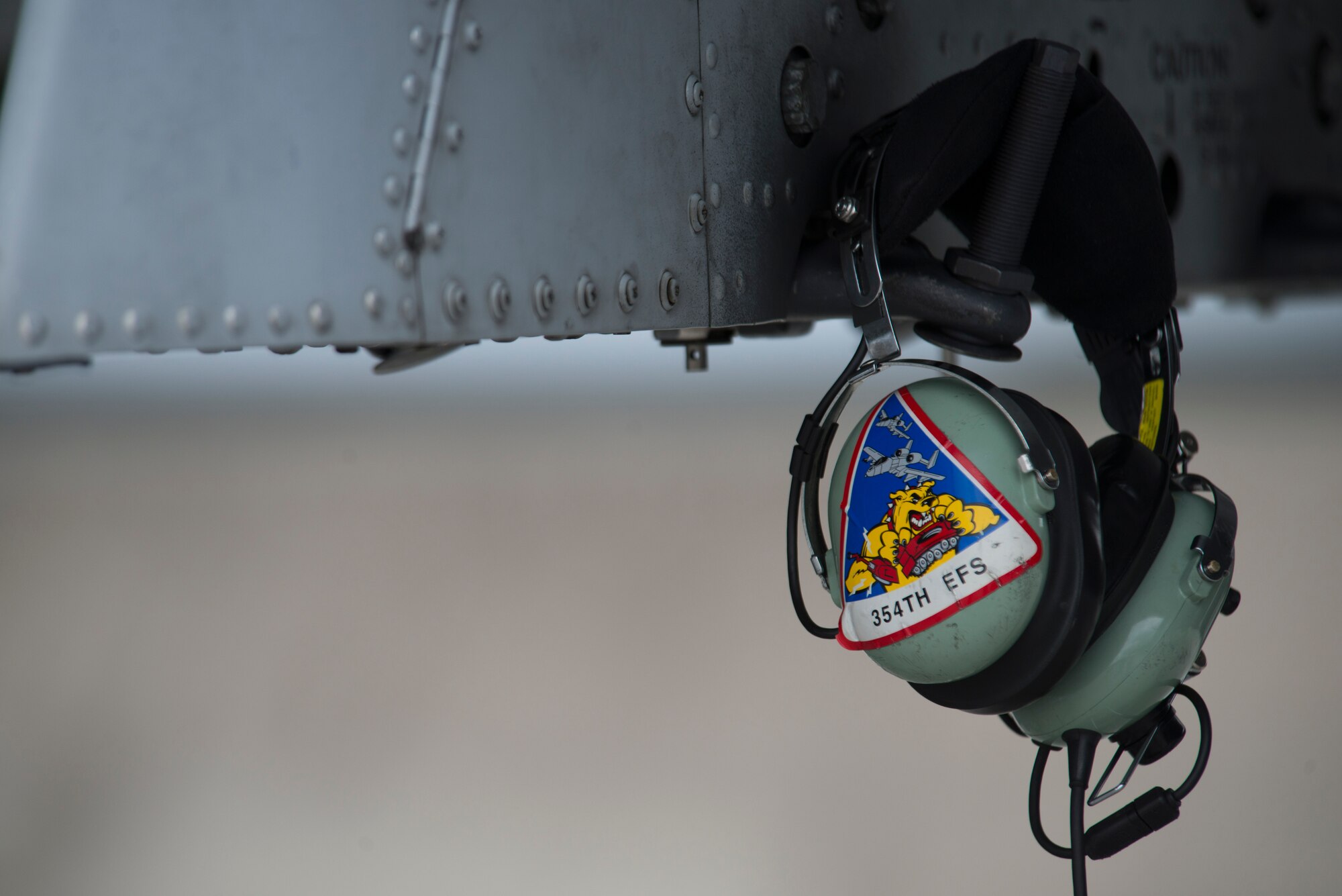 A 354th Expeditionary Fighter Squadron patch is displayed on the headset of an A-10 Thunderbolt II attack aircraft crew chief during a theater security package deployment to Lask Air Base, Poland, July 13, 2015. The U.S. and Polish air forces will conduct training aimed at strengthening interoperability and demonstrating the countries' shared commitment to the security and stability of Europe. (U.S. Air Force photo by Staff Sgt. Christopher Ruano/Released)
