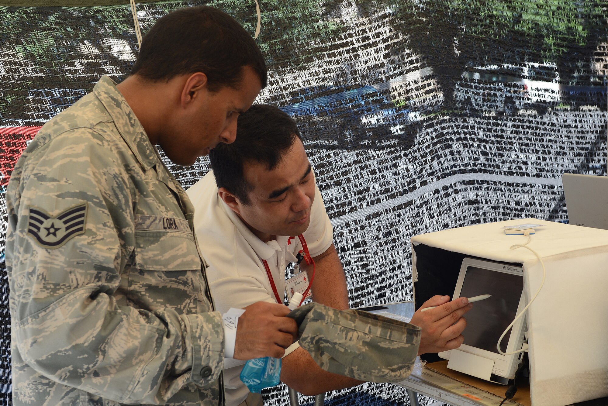 Staff Sgt. Denny Lora, 374th Communications Squadron systems control supervisor, fills out a questionnaire allowing him to donate blood to the Japanese Red Cross Society at Yokota Air Base, Japan, July 21, 2015. The blood drive was a two-day event hosted by the Japan Air Self-Defense Force and JRCS. (U.S. Air Force photo by Airman 1st Class David C. Danford/Released)
