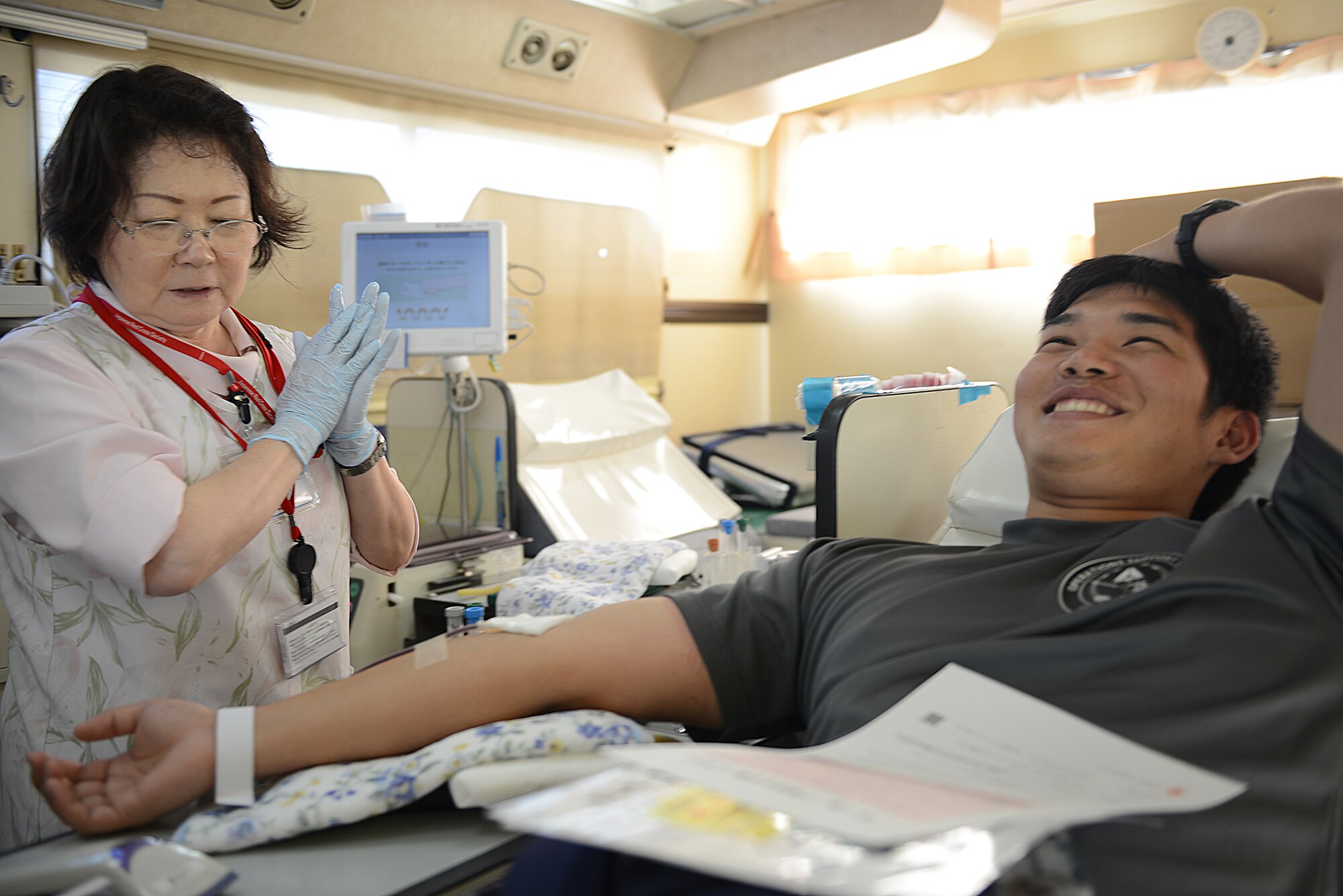 A Japan Air Self-Defense Force member donates blood to the Japanese Red Cross Society at Yokota Air Base, Japan, July 21, 2015. The JRCS has provided humanitarian aid and disaster relief for over 130 years. (U.S. Air Force photo by Airman 1st Class David C. Danford/Released)