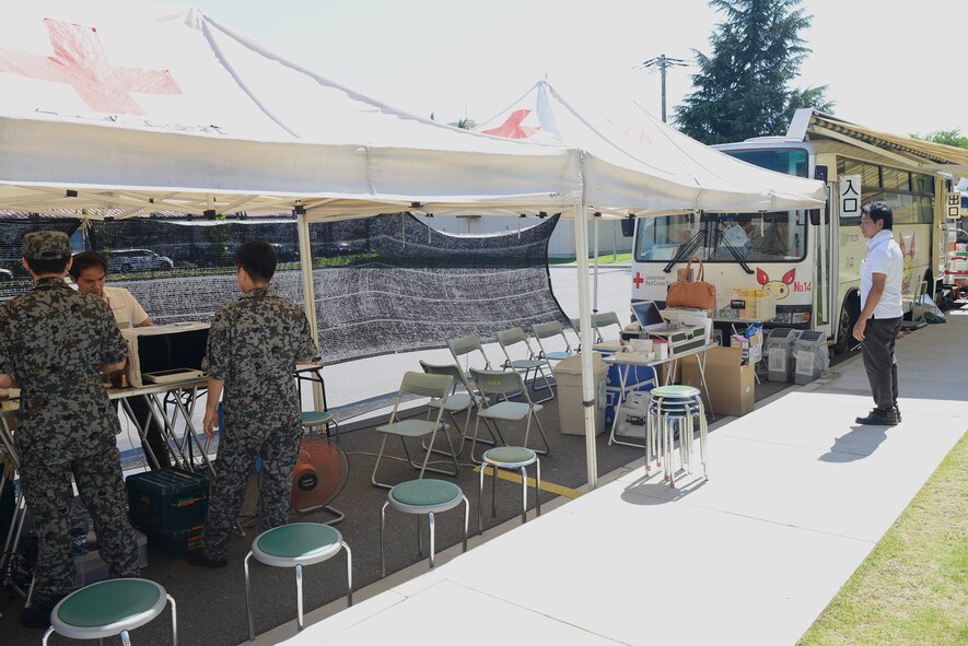 U.S. Airmen and members of the Japan Air Self-Defense Force donate blood to the Japanese Red Cross Society at Yokota Air Base, Japan, July 21, 2015.  The JRCS, founded in 1877 as the Philanthropic Society, saves an estimated 1.2 million lives a year. (U.S. Air Force photo by Airman 1st Class David C. Danford/Released)