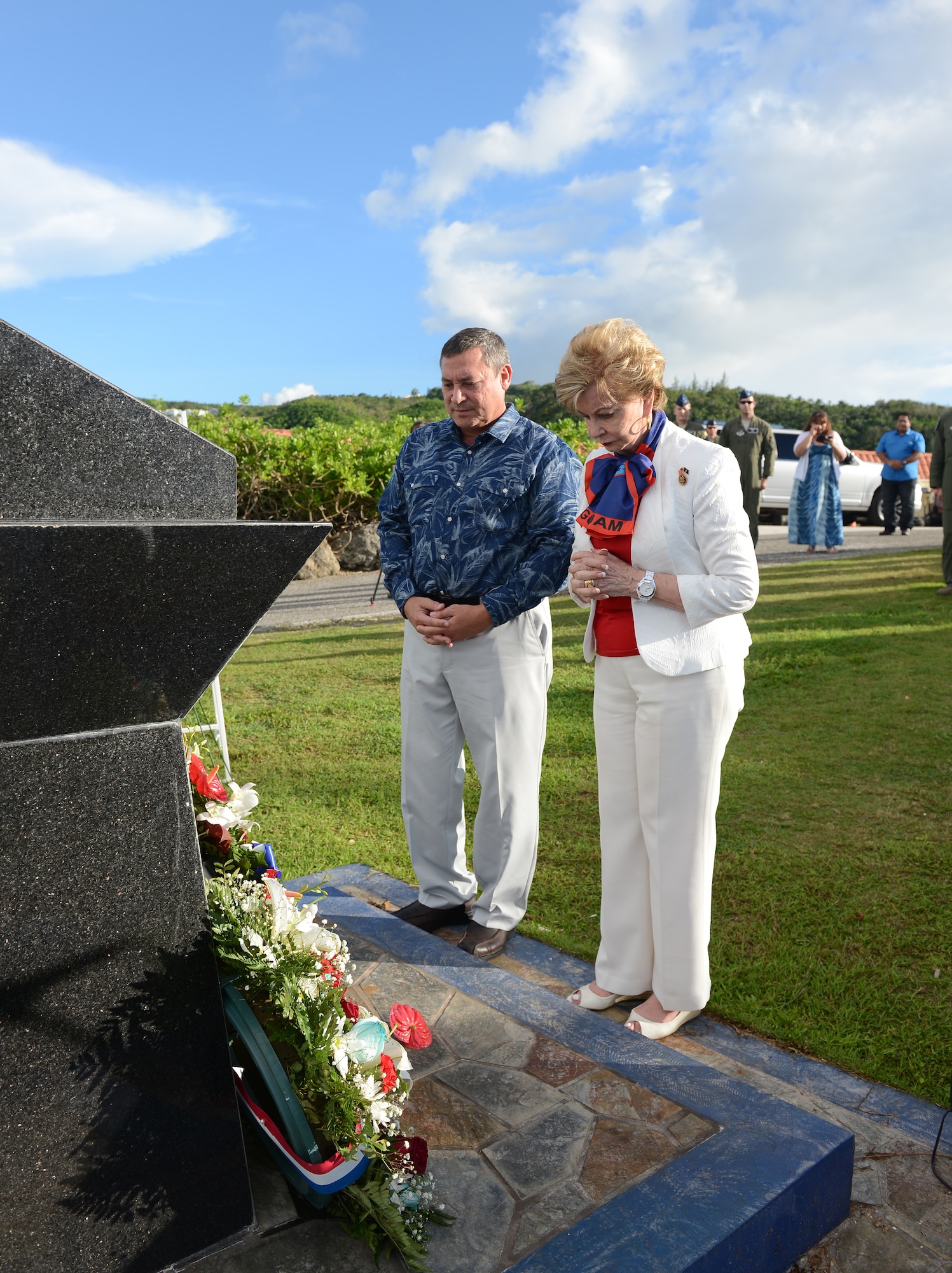 Eddie Calvo, governor of Guam, and Madeleine Bordallo, Guam’s U.S. Congress representative, pay respects to the fallen Airmen during the Raider 21 memorial July 21, 2015, in Adelup, Guam. The monument, constructed at the Ricardo J. Bordallo Governor’s Complex in 2009, was built and marked with the names of the six Airmen who lost their lives. (U.S. Air Force photo by Airman 1st Class Arielle Vasquez/Released)