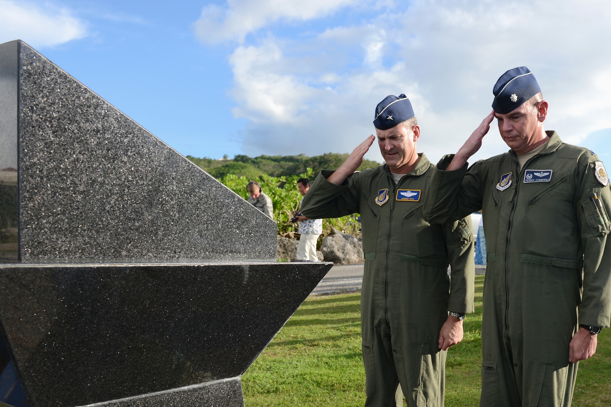 Brig. Gen. Andrew Toth, 36th Wing commander, and Lt. Col. Dennis Cummings, 20th EBS commander, pay respects to the fallen Airmen during the Raider 21 memorial July 21, 2015, in Adelup, Guam. The memorial service was held in remembrance of Raider 21, a B-52 Stratofortress aircrew that died during a Liberation Day flyover July 21, 2008, when their aircraft crashed. (U.S. Air Force photo by Airman 1st Class Arielle Vasquez/Released)