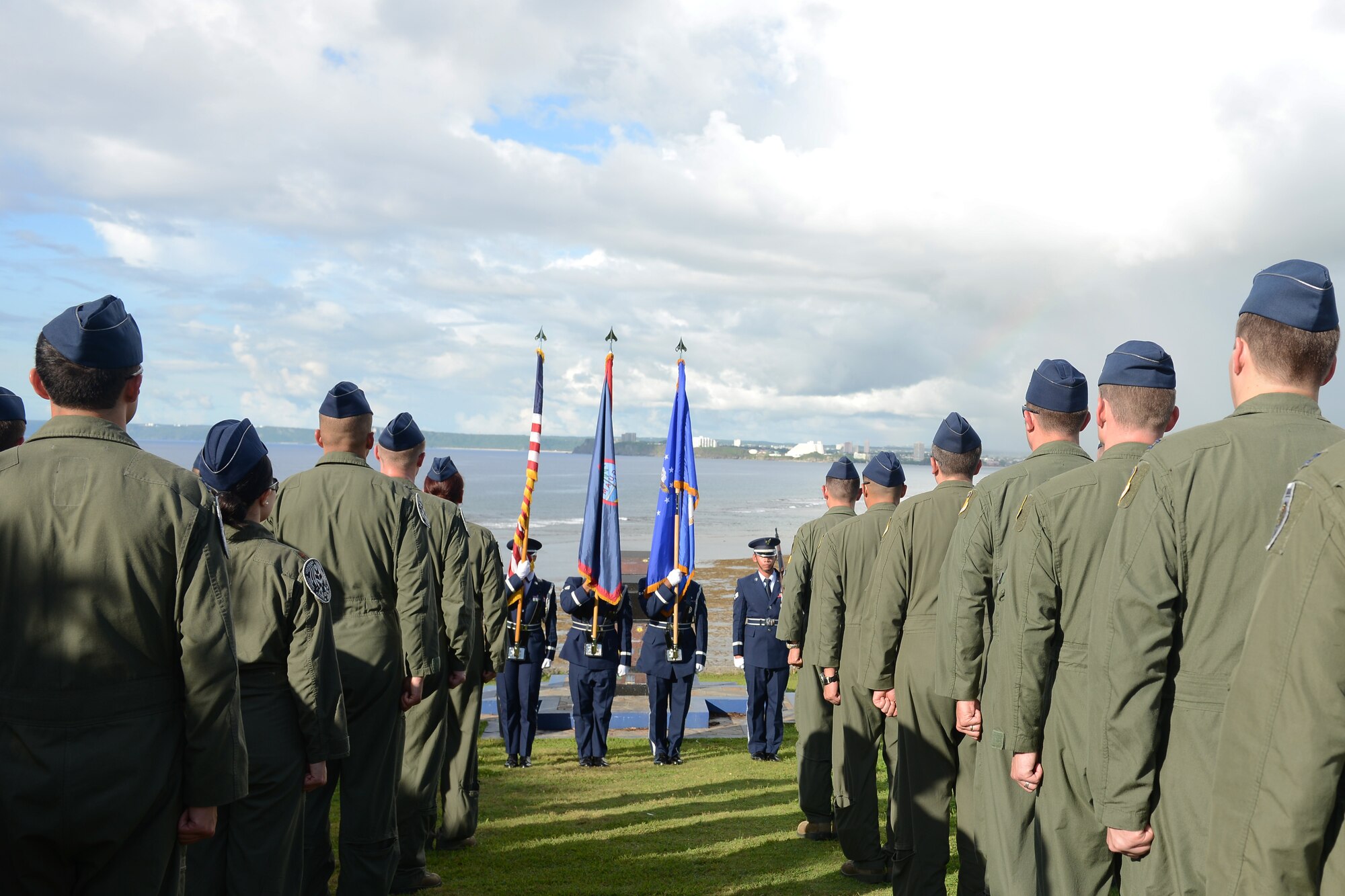 Airmen from the 20th Expeditionary Bomb Squadron currently deployed to Andersen from Barksdale Air Force Base, Louisiana, stand at attention for the Guam Hymn during the Raider 21 memorial ceremony July 21, 2015, in Adelup, Guam. Members of Team Andersen and representatives from the Government of Guam gathered together to remember the six Airmen who lost their lives when a B-52 Stratofortress with call sign  Raider 21 crashed off the coast of Guam July 21, 2008. (U.S. Air Force photo by Airman 1st Class Arielle Vasquez/Released)