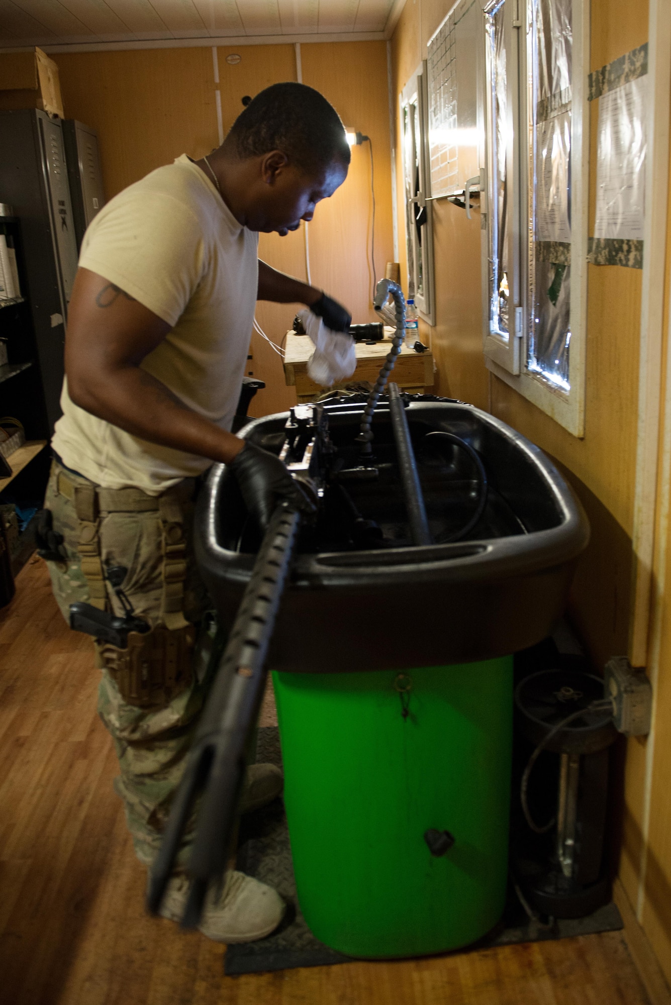 U.S. Air Force Staff Sgt. Robert Smith, 455th Expeditionary Aircraft Maintenance HH-60 Pave Hawk weapons, inspects an M2 .50 caliber machine gun at Bagram Airfield, Afghanistan, July 21, 2015. The weapon system maintainers work to keep the Pave Hawks armed so that the combat rescue mission in Afghanistan is successful. (U.S. Air Force photo by Tech. Sgt. Joseph Swafford/Released)