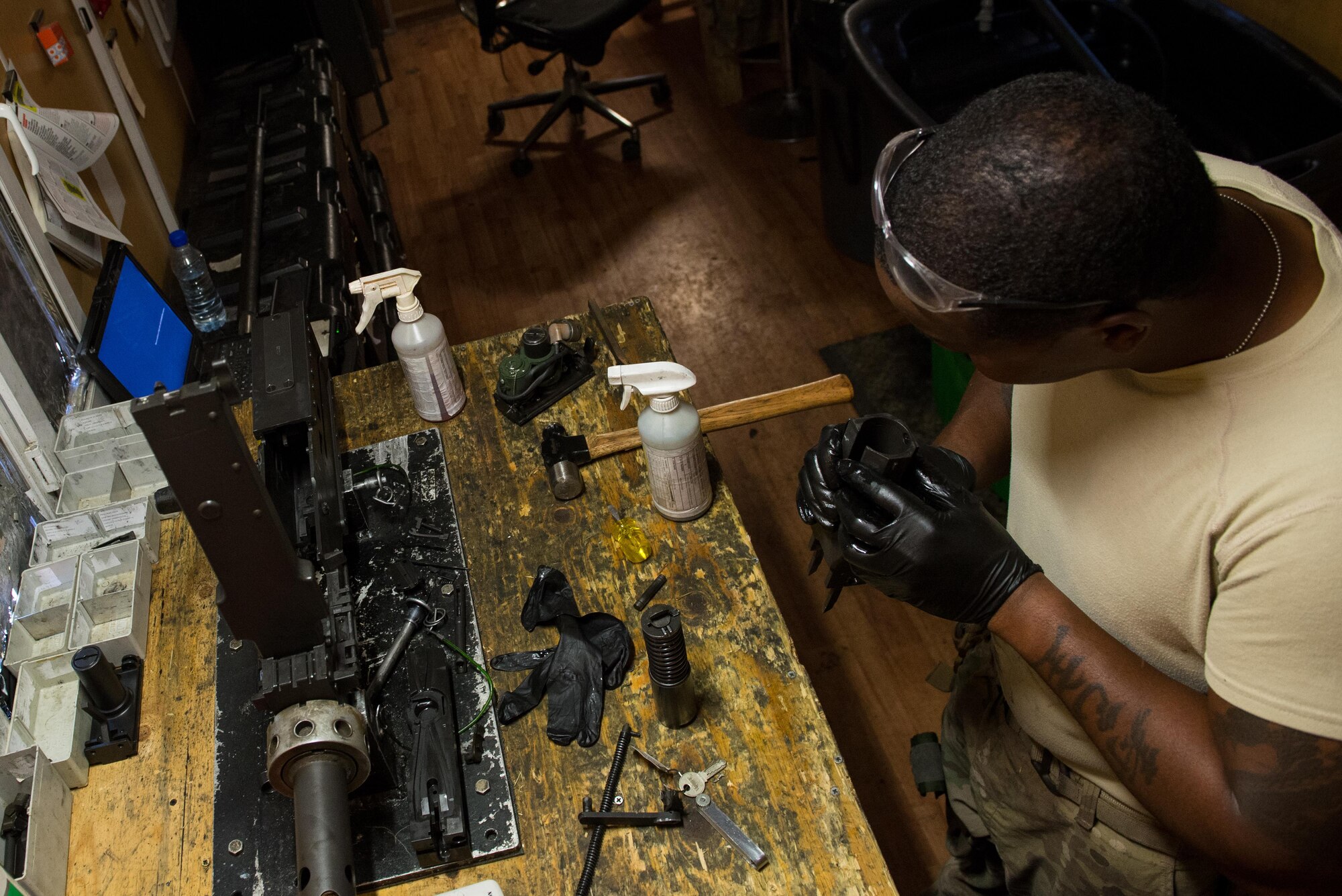 U.S. Air Force Staff Sgt. Robert Smith, 455th Expeditionary Aircraft Maintenance HH-60 Pave Hawk weapons, inspects an M2 .50 caliber machine gun at Bagram Airfield, Afghanistan, July 21, 2015. The weapon system maintainers work to keep the Pave Hawks armed so that the combat rescue mission in Afghanistan is successful. (U.S. Air Force photo by Tech. Sgt. Joseph Swafford/Released)