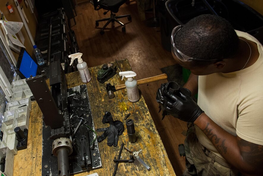U.S. Air Force Staff Sgt. Robert Smith, 455th Expeditionary Aircraft Maintenance HH-60 Pave Hawk weapons, inspects an M2 .50 caliber machine gun at Bagram Airfield, Afghanistan, July 21, 2015. The weapon system maintainers work to keep the Pave Hawks armed so that the combat rescue mission in Afghanistan is successful. (U.S. Air Force photo by Tech. Sgt. Joseph Swafford/Released)