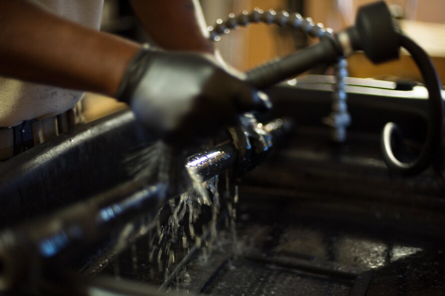 U.S. Air Force Staff Sgt. Robert Smith, 455th Expeditionary Aircraft Maintenance HH-60 Pave Hawk weapons, cleans an M2 .50 caliber machine gun at Bagram Airfield, Afghanistan, July 21, 2015. The weapon system maintainers work to keep the Pave Hawks armed so that the combat rescue mission in Afghanistan is successful. (U.S. Air Force photo by Tech. Sgt. Joseph Swafford/Released)