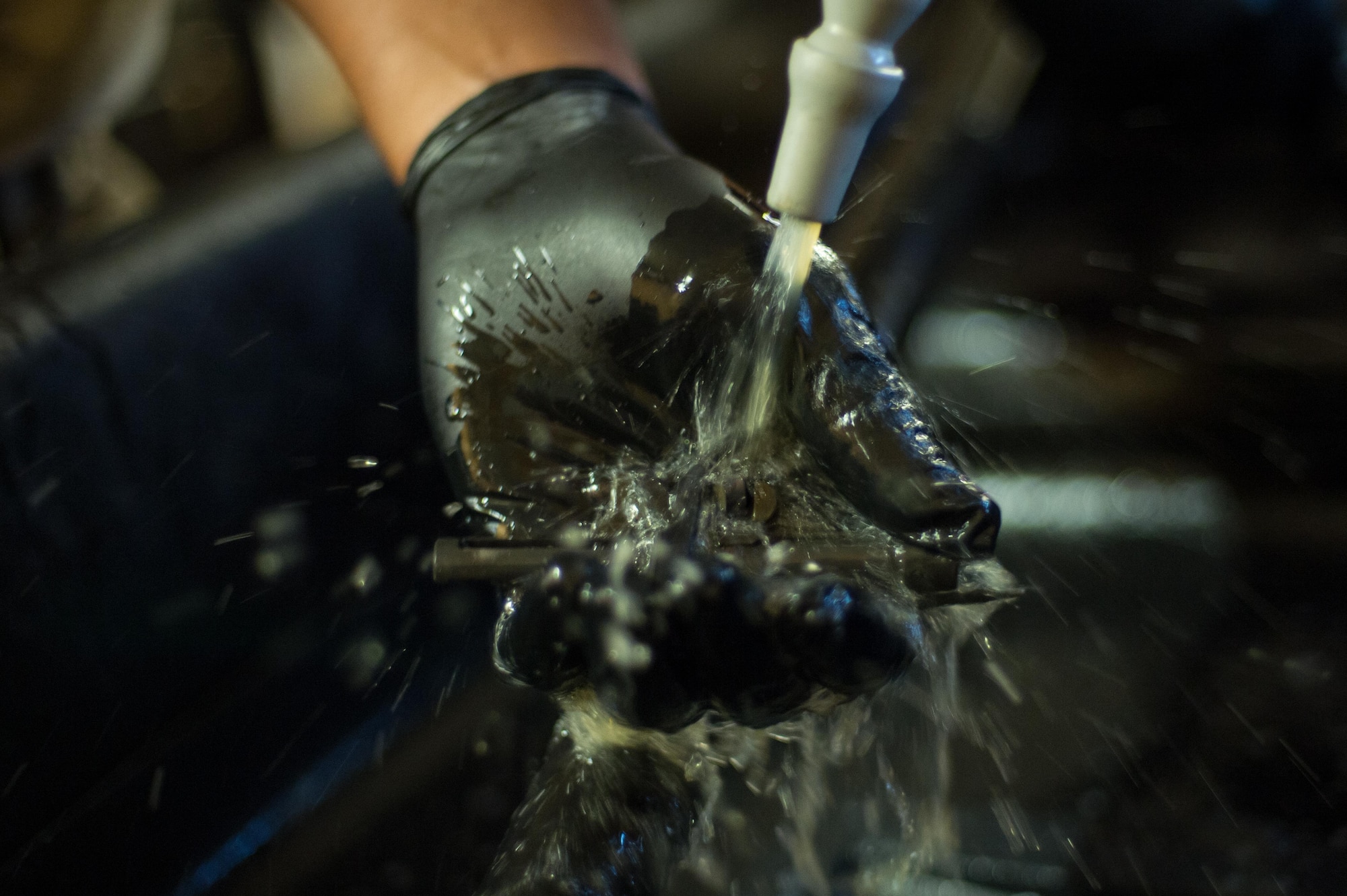 U.S. Air Force Staff Sgt. Robert Smith, 455th Expeditionary Aircraft Maintenance HH-60 Pave Hawk weapons, cleans an M2 .50 caliber machine gun at Bagram Airfield, Afghanistan, July 21, 2015. The weapon system maintainers work to keep the Pave Hawks armed so that the combat rescue mission in Afghanistan is successful. (U.S. Air Force photo by Tech. Sgt. Joseph Swafford/Released)