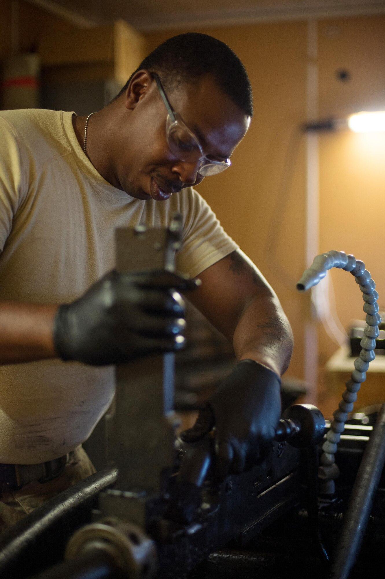 U.S. Air Force Staff Sgt. Robert Smith, 455th Expeditionary Aircraft Maintenance HH-60 Pave Hawk weapons, cleans an M2 .50 caliber machine gun at Bagram Airfield, Afghanistan, July 21, 2015. The weapon system maintainers work to keep the Pave Hawks armed so that the combat rescue mission in Afghanistan is successful. (U.S. Air Force photo by Tech. Sgt. Joseph Swafford/Released)