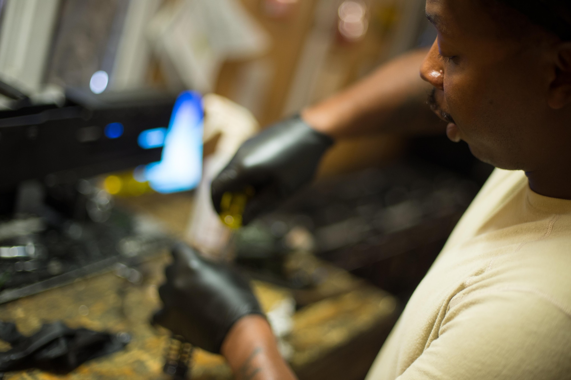 U.S. Air Force Staff Sgt. Robert Smith, 455th Expeditionary Aircraft Maintenance HH-60 Pave Hawk weapons, inspects an M2 .50 caliber machine gun at Bagram Airfield, Afghanistan, July 21, 2015. The weapon system maintainers work to keep the Pave Hawks armed so that the combat rescue mission in Afghanistan is successful. (U.S. Air Force photo by Tech. Sgt. Joseph Swafford/Released)