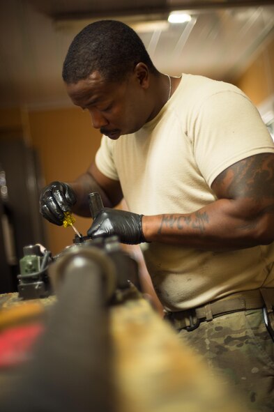 U.S. Air Force Staff Sgt. Robert Smith, 455th Expeditionary Aircraft Maintenance HH-60 Pave Hawk weapons, inspects an M2 .50 caliber machine gun at Bagram Airfield, Afghanistan, July 21, 2015. The weapon system maintainers work to keep the Pave Hawks armed so that the combat rescue mission in Afghanistan is successful. (U.S. Air Force photo by Tech. Sgt. Joseph Swafford/Released)