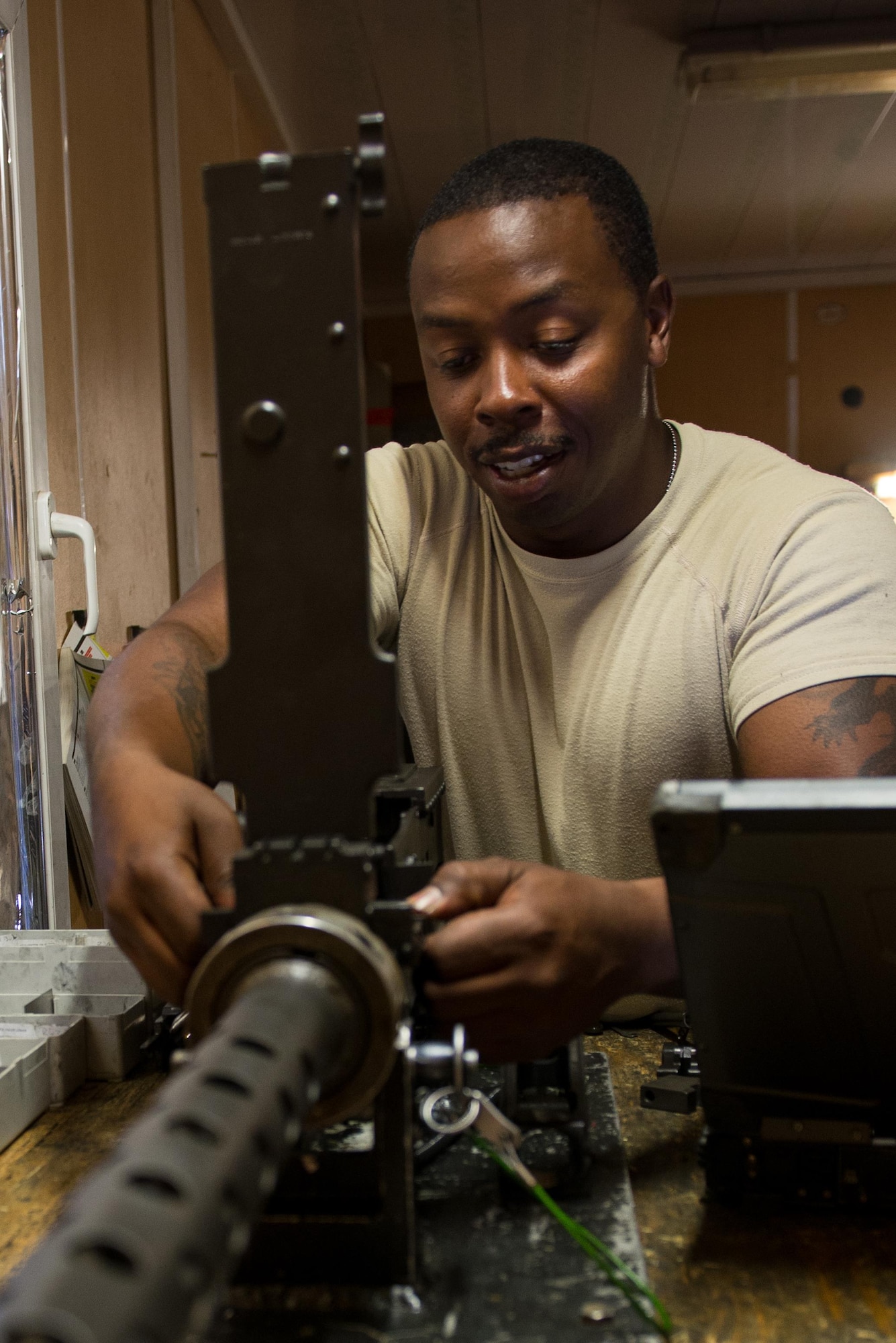U.S. Air Force Staff Sgt. Robert Smith, 455th Expeditionary Aircraft Maintenance HH-60 Pave Hawk weapons, inspects an M2 .50 caliber machine gun at Bagram Airfield, Afghanistan, July 21, 2015. The weapon system maintainers work to keep the Pave Hawks armed so that the combat rescue mission in Afghanistan is successful. (U.S. Air Force photo by Tech. Sgt. Joseph Swafford/Released)
