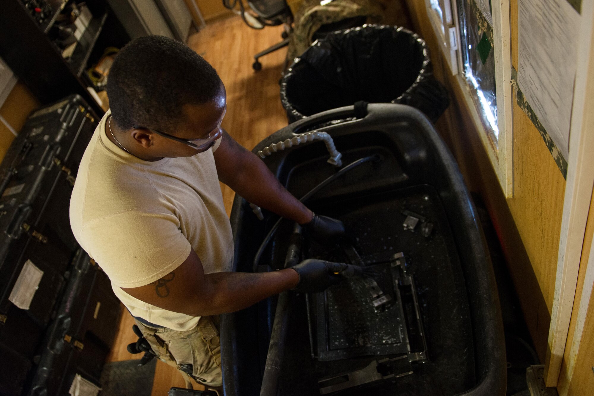 U.S. Air Force Staff Sgt. Robert Smith, 455th Expeditionary Aircraft Maintenance HH-60 Pave Hawk weapons, cleans an M2 .50 caliber machine gun at Bagram Airfield, Afghanistan, July 21, 2015. The weapon system maintainers work to keep the Pave Hawks armed so that the combat rescue mission in Afghanistan is successful. (U.S. Air Force photo by Tech. Sgt. Joseph Swafford/Released)