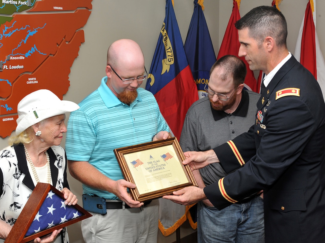 The family of Philip L. Burney, a budget analyst in the Operations Division, is presented with a United States flag, flown over the U.S. Capitol.during a ceremony at the district June, 9, 2015.   Burney passed away unexpectedly Feb. 1, 2015.  
