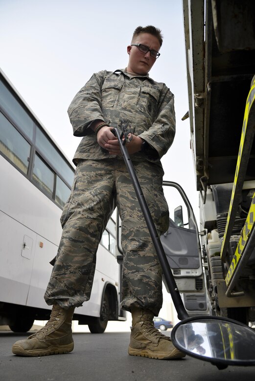 Senior Airman Patrick searches the bottom of a vehicle for contraband and explosives at an undisclosed location in Southwest Asia July 13, 2015. Airman Patrick is a security forces member assigned to the 380th Expeditionary Security Forces Squadron, vehicle search area. (U.S. Air Force photo/Tech. Sgt. Christopher Boitz)