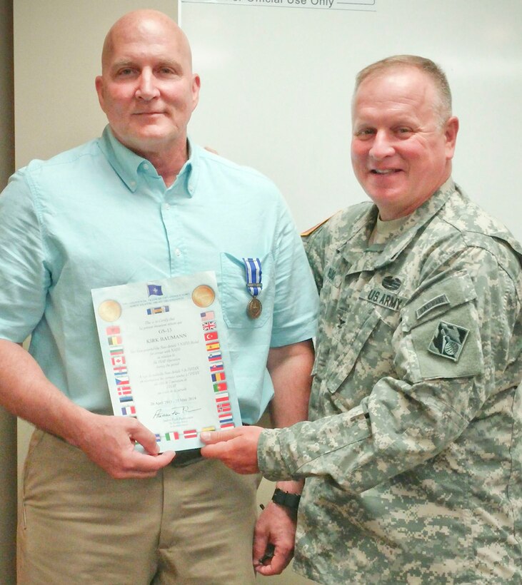 Huntsville Center Commander Col. Robert Ruch presents Kirk Baumann, Huntsville Center Ordnance and Explosives Directorate project manager, with the Non-Article 5 NATO Medal for service July 22. The medal was awarded for Baumann’s service in relation to International Security Assistance Force Operations from April 2013 to May 2014. Eligibility for the Non-Article 5 Medal for service with the ISAF are those who are members of units or staffs as set out in the Joint Operations Area taking part in operations in Afghanistan.