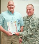 Huntsville Center Commander Col. Robert Ruch presents Kirk Baumann, Huntsville Center Ordnance and Explosives Directorate project manager, with the Non-Article 5 NATO Medal for service July 22. The medal was awarded for Baumann’s service in relation to International Security Assistance Force Operations from April 2013 to May 2014. Eligibility for the Non-Article 5 Medal for service with the ISAF are those who are members of units or staffs as set out in the Joint Operations Area taking part in operations in Afghanistan.