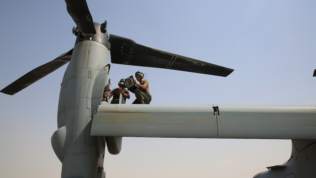 U.S. Marine Lance Cpl. Zachary Claus and Lance Cpl. Luis Alvarez, avionics technicians with Marine Medium Tiltrotor Squadron – 165 (VMM – 165), Special Purpose Marine Air – Ground Task Force – Crisis Response – Central Command, take multimeter readings from the engine of an MV–22 Osprey, July 15, 2015, in Southwest Asia. The Marines of VMM – 165 celebrate the unit’s 50th anniversary while deployed with the SPMAGTF; providing long range assault support, troop transport and cargo delivery in the Central Command Area of Operations, as well as support to the Tactical Recovery of Aircraft and Personnel.
