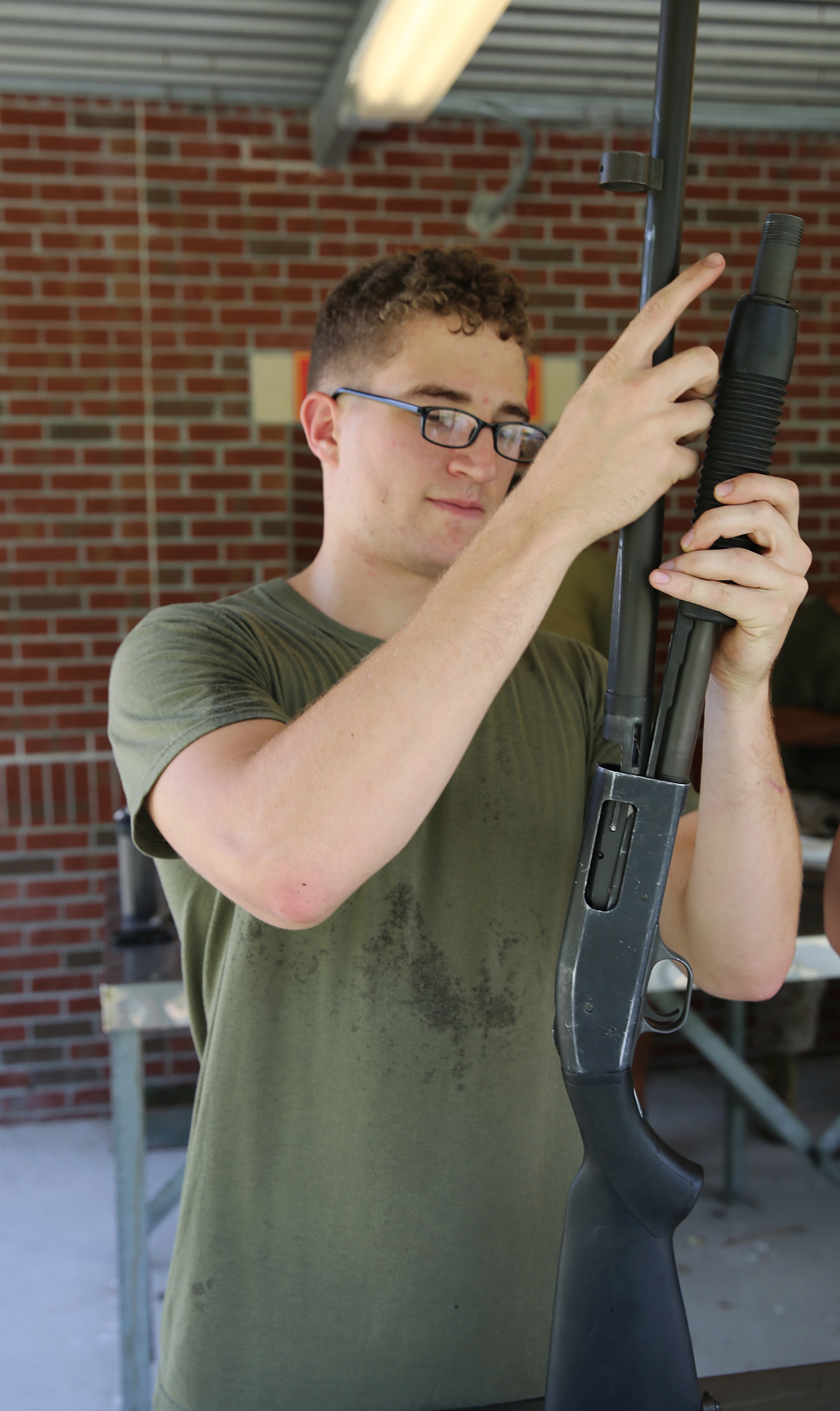 U.S. Marine Corps Cpl. Robert Clark, 22nd Marine Expeditionary Unit (MEU) administrative assistant chief and native of Gastonia, N.C., reassembles a Mossburg 12 gauge shotgun model 500 at Marine Corps Base Camp Lejeune, N.C., July 22, 2015. The MEU preforms regular weapons maintenance to maintain a high level of readiness. (U.S. Marine Corps photo by Cpl. Caleb McDonald)