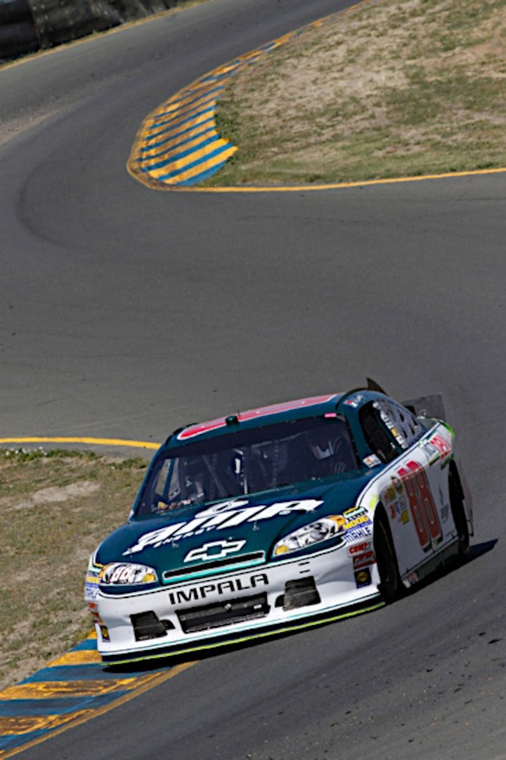Dale Earnhardt Jr., driver of the No. 88 National Guard NASCAR racecar, hugs the corners of the track at the Infineon Raceway in Sonoma Calif., Sunday, June 26, 2011. Earnhardt was involved in a multi-car crash during the race and was forced to throw in the towel after repairs to his racecar were not successful.