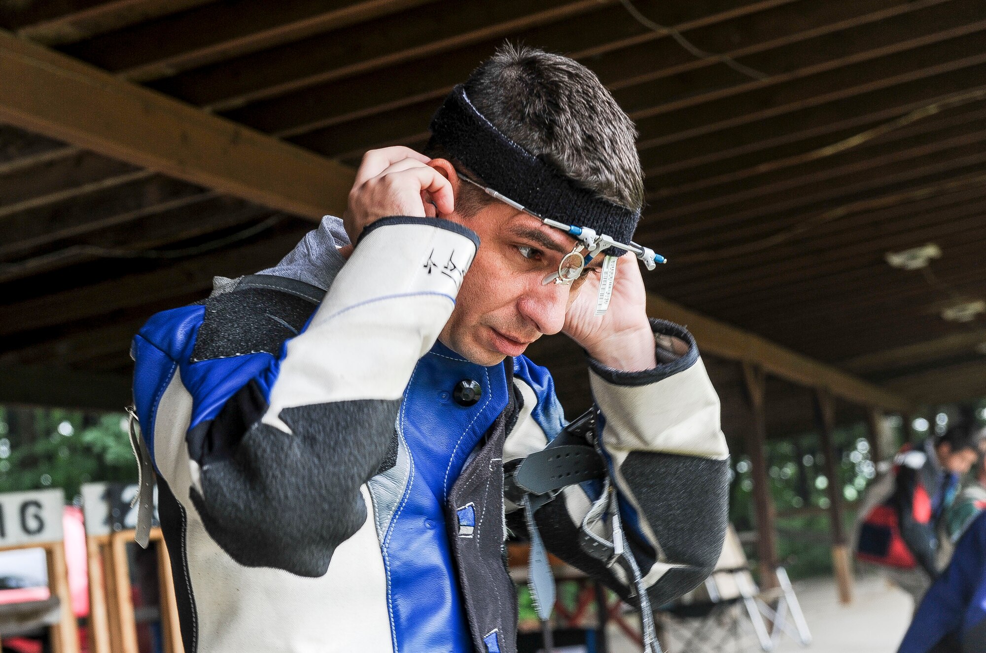 Lt. Col. Mark Gould puts on his protective eyewear as he prepares to shoot targets during a training class in New Freedom, Pa., June 26, 2015. Gould, a foreign liaison officer for the Defense Intelligence Agency’s Office of Partner Engagement at the Pentagon, has been involved in competitive shooting for the past 23 years and has been a member of the Air Force International Rifle Team for 17 years. (U.S. Air Force photo/Staff Sgt. Christopher Gross)