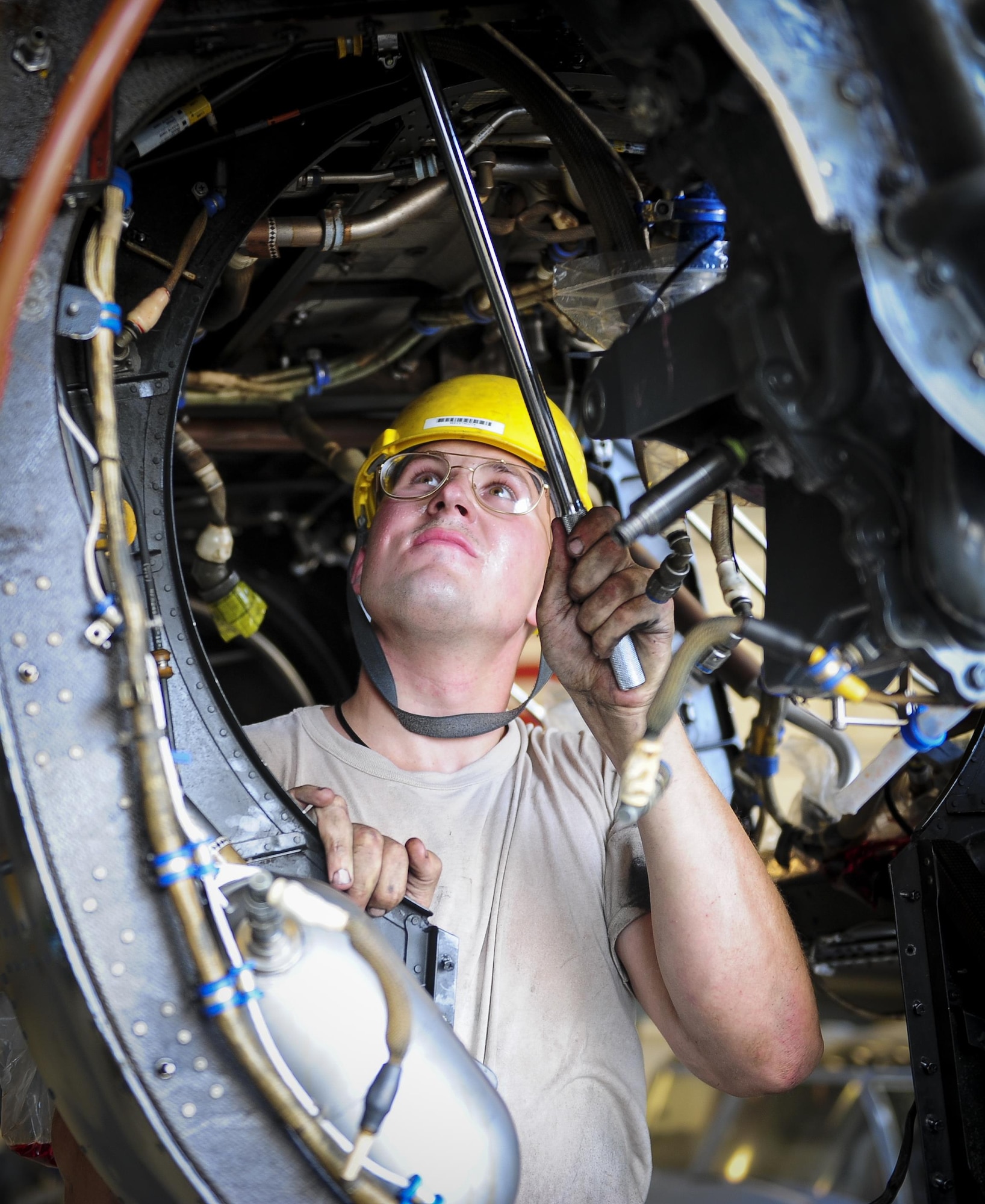 Airman 1st Class Richard Bassett, 801st Special Operations Aircraft Maintenance Squadron crew chief, loosens torque bolts on a CV-22B Osprey gear box on the flight line at Hurlburt Field Fla., July 20, 2015. The 801st SOAMXS’s mission is to perform all equipment maintenance in support of worldwide special operations missions in response to national command authority taskings for the CV-22B Osprey and the MC-130H Talon II. Maintenance includes aircraft servicing, phase inspections, troubleshooting, repair, modifications and launch recovery for all aircraft. (U.S. Air Force photo/Senior Airman Meagan Schutter)