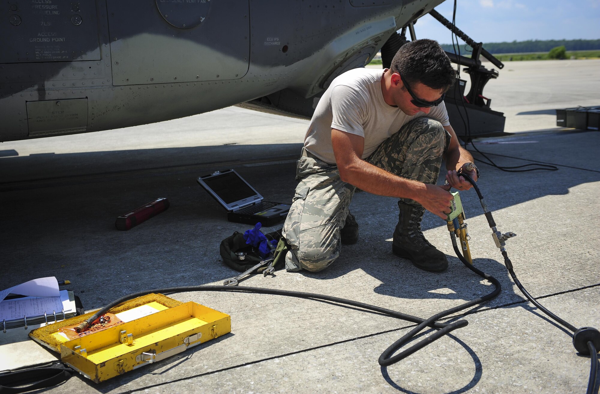 Senior Airman Brian Sibley, 801st Special Operations Aircraft Maintenance Squadron crew chief, attaches a servicing hose to perform maintenance on a CV-22B Osprey at Hurlburt Field Fla., July 20, 2015. The 801st SOAMXS’s mission is to perform all equipment maintenance in support of worldwide special operations missions in response to national command authority taskings for the CV-22B Osprey and the MC-130H Talon II. Maintenance includes aircraft servicing, phase inspections, troubleshooting, repair, modifications and launch recovery for all aircraft. (U.S. Air Force photo/Senior Airman Meagan Schutter)