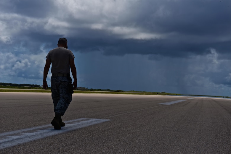 U.S. Air Force Capt. Clark Morgan, 36th Mobility Response Squadron contingency engineer, surveys the pavement on Wake Airfield for cracks and other damage July 20, 2015, Wake Island. A team with the 36th CRG at Andersen Air Force Base, Guam, deployed to the atoll to assist in airfield storm recovery efforts, and surveyed the runway to ensure adequate flightline safety. (U.S. Air Force photo by Senior Airman Alexander W. Riedel/Released)
