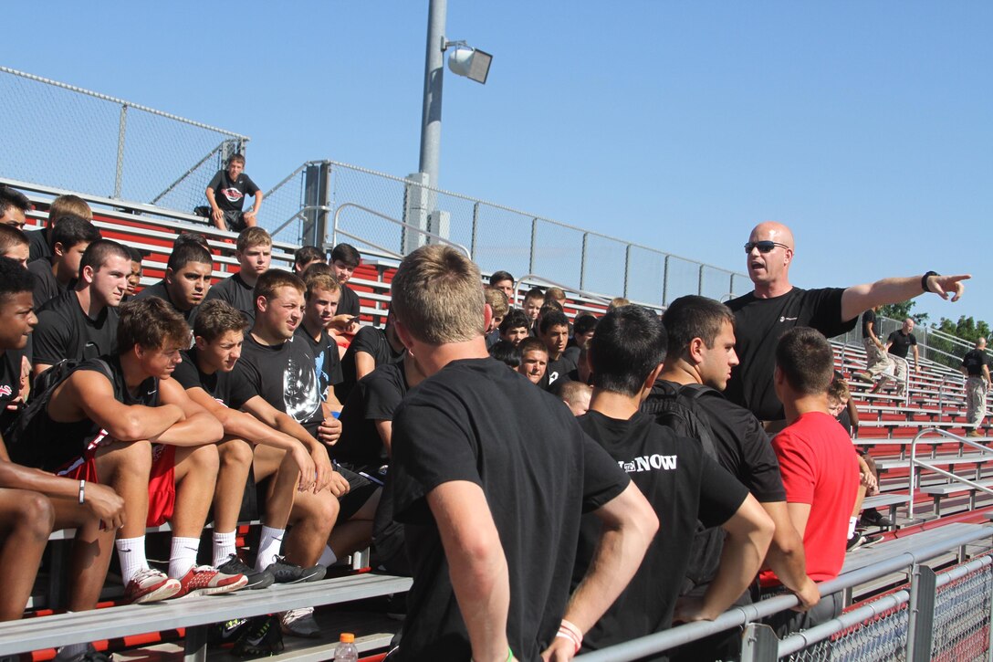 Capt. Joseph McGinnis, executive officer of Recruiting Station New Jersey, directs football players to the leadership endurance course during a leadership seminar with the Hunterdon Central Regional High School football team, July 22, 2015. 