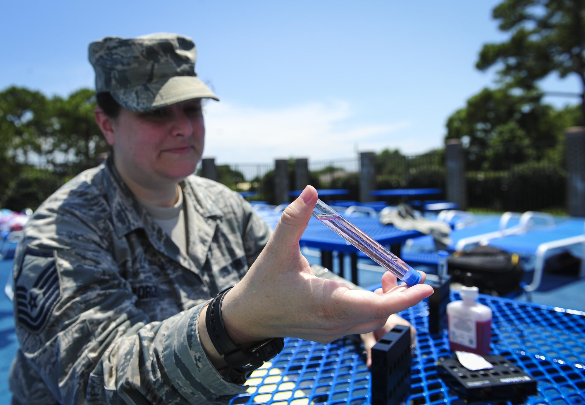 Master Sgt. Melissa Worley, 1st Special Operations Support Squadron independent duty medical technician, mixes phenol dye with pool water to test for pH and chlorine levels at the Aquatic Center on Hurlburt Field, Fla., July 22, 2015. Worley and other IDMTs train with bioenvironmental to ensure proficiency when testing water conditions. (U.S. Air Force photo/Senior Airman Meagan Schutter)