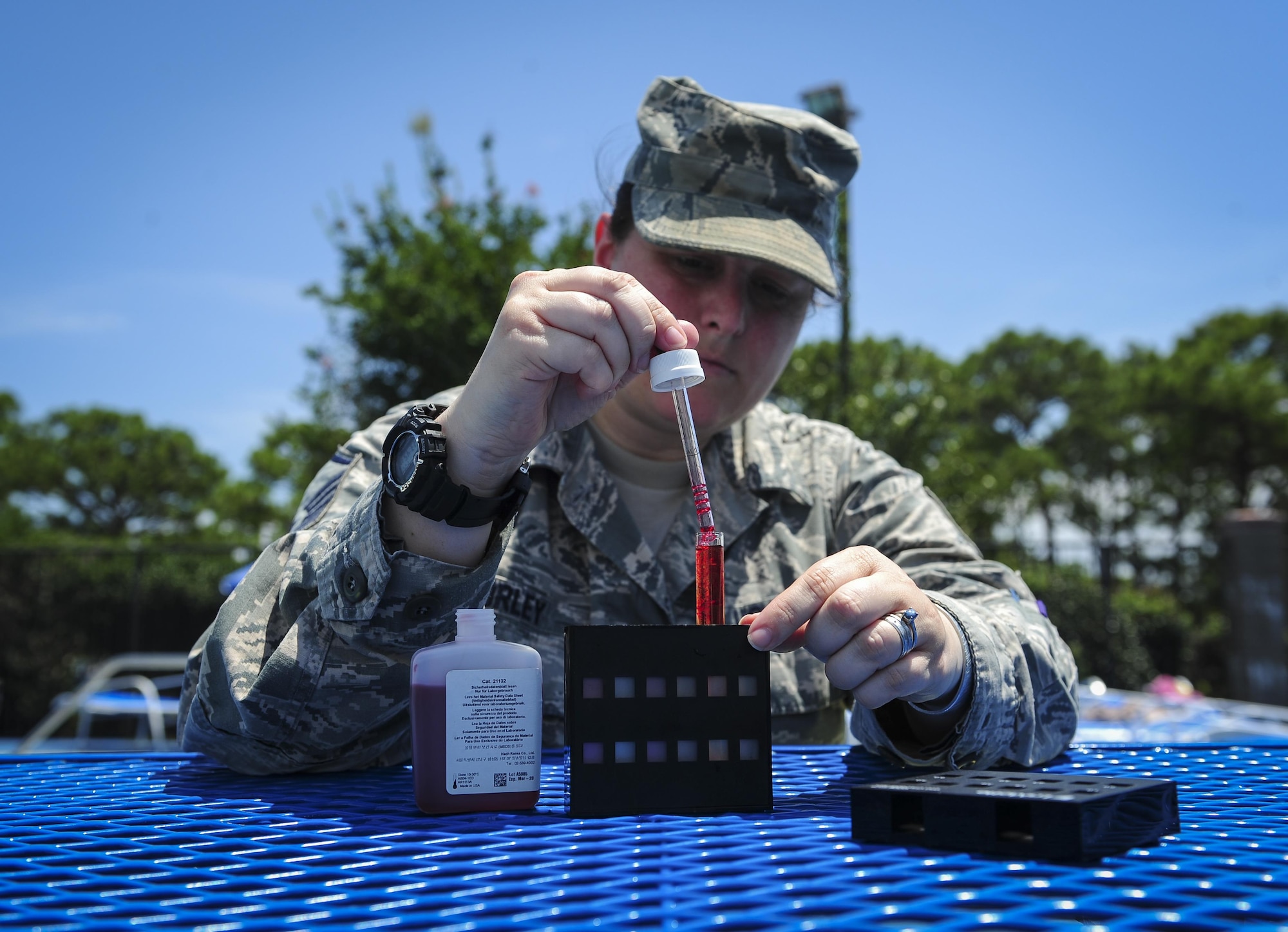 Master Sgt. Melissa Worley, 1st Special Operations Support Squadron independent duty medical technician, adds phenol dye with pool water to test for pH and chlorine levels at the Aquatic Center on Hurlburt Field, Fla., July 22, 2015. Worley and other IDMTs train with bioenvironmental to ensure proficiency when testing water conditions. (U.S. Air Force photo/Senior Airman Meagan Schutter)