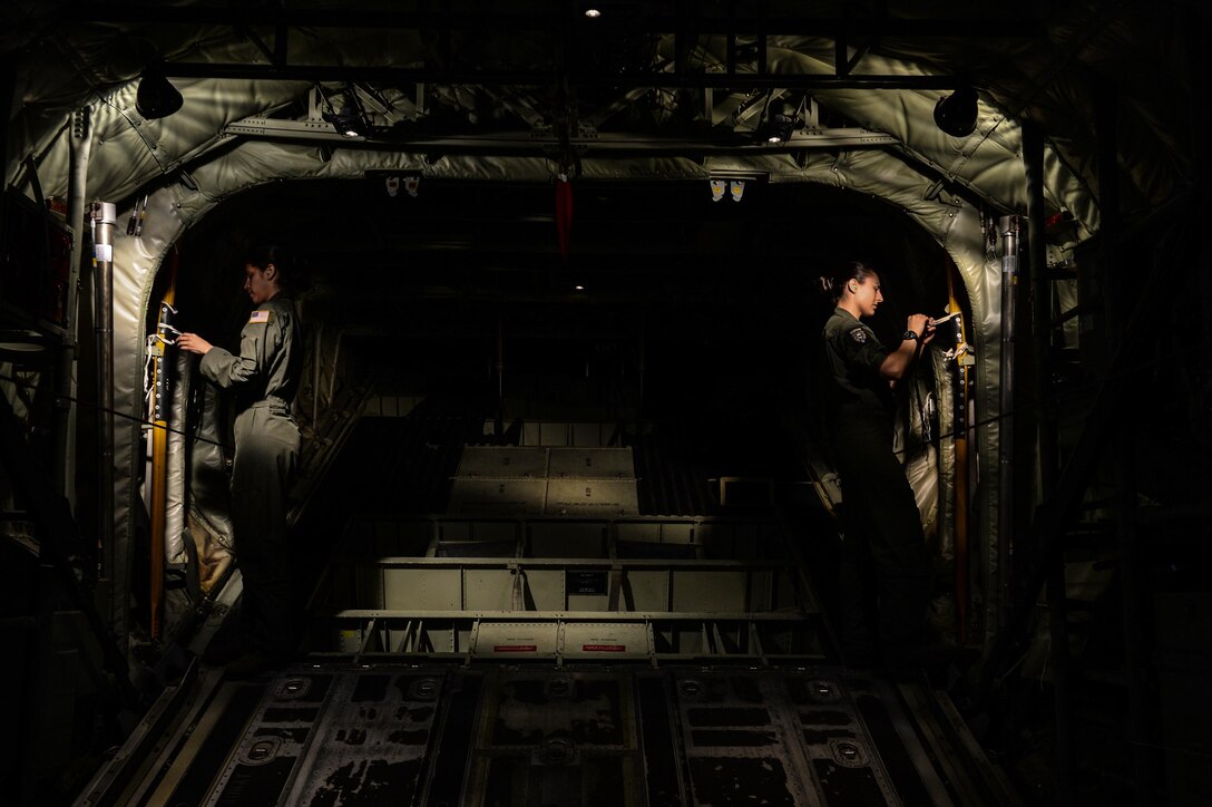 Senior Airmen Giselle Toro and Tristen Geray, 37th Airlift Squadron loadmasters, prepare for a U.S. and Bulgarian air force formation flight over Plovdiv, Bulgaria, July 14, 2015. Loadmasters are responsible for the proper loading of cargo onto an aircraft and ensuring passengers are safe and comfortable during travel. In addition to securing cargo, Toro and Geray were both responsible for the safe departure of paratroopers from the aircraft during the flight. (U.S. Air Force photo/Senior Airman Nicole Sikorski)