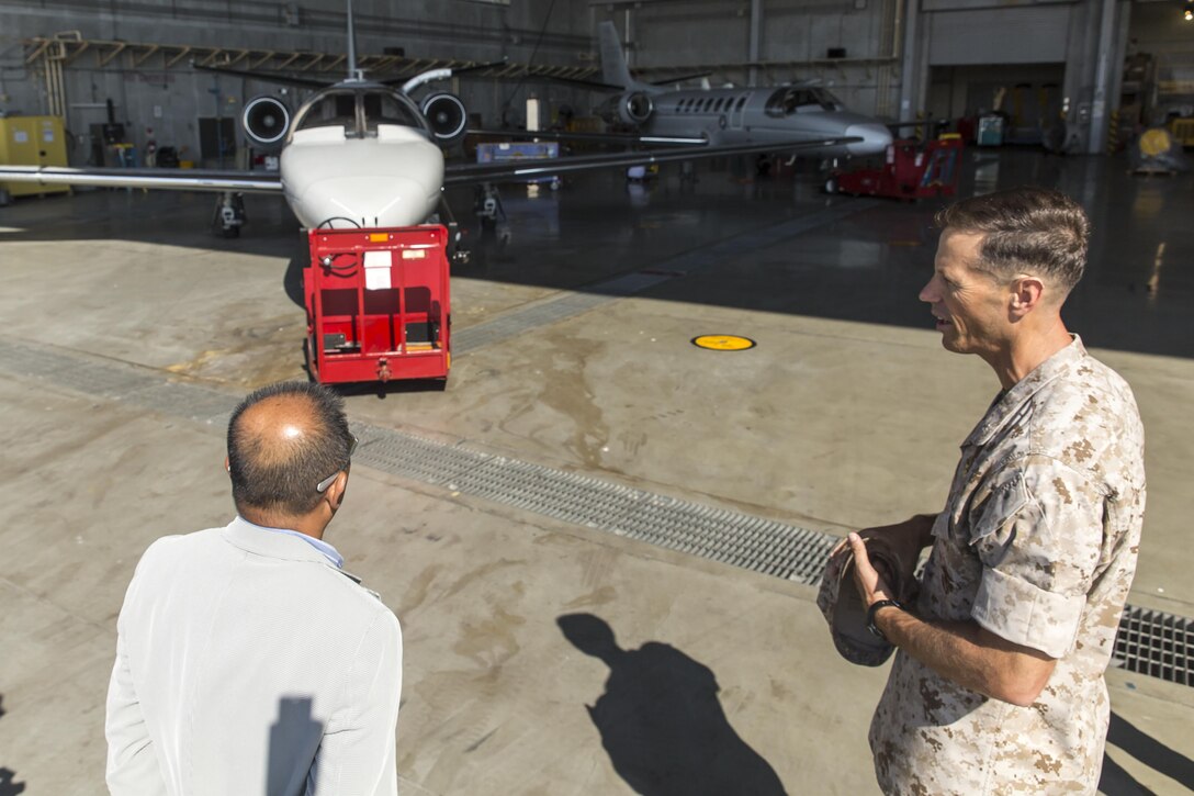 Toshiyuki Kuwabara, left, chairman of the Iwakuni City Council, listens to Lt. Col. James Hurd, right, executive officer for Marine Corps Air Station Futenma, Japan, explains the use of the UC-35D Cessna during a visit to the air station to conduct a study tour, July 16, 2015. Iwakuni City Council, Chugoku Shikoku Defense Bureau officials, Okinawa Defense Bureau officials and Ginowan City Council members visited MCAS Futenma to help deepen the their understanding on national security here, and the mission of MCAS Futenma in support of III Marine Expeditionary Force’s aviation warfighting capabilities.