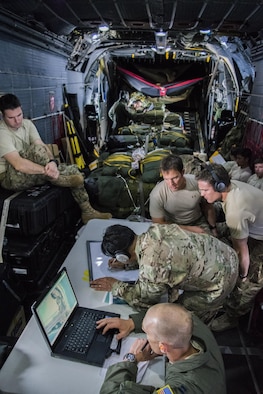 Aircrew from the 1st Special Operations Squadron and Special Tactics operators from the 320th Special Tactics Squadron, conduct mission planning for the opening of Wake Island while enroute to Andersen Air Base, Guam, July 18, 2015. Members from the 353rd Special Operations Group worked with the 36th Contingency Response Group from Andersen Air Base, Guam, to open Wake Island air field after Typhoon Halola passed through the island.  (Photo courtesy of Staff Sgt. Matthew Sharp)  