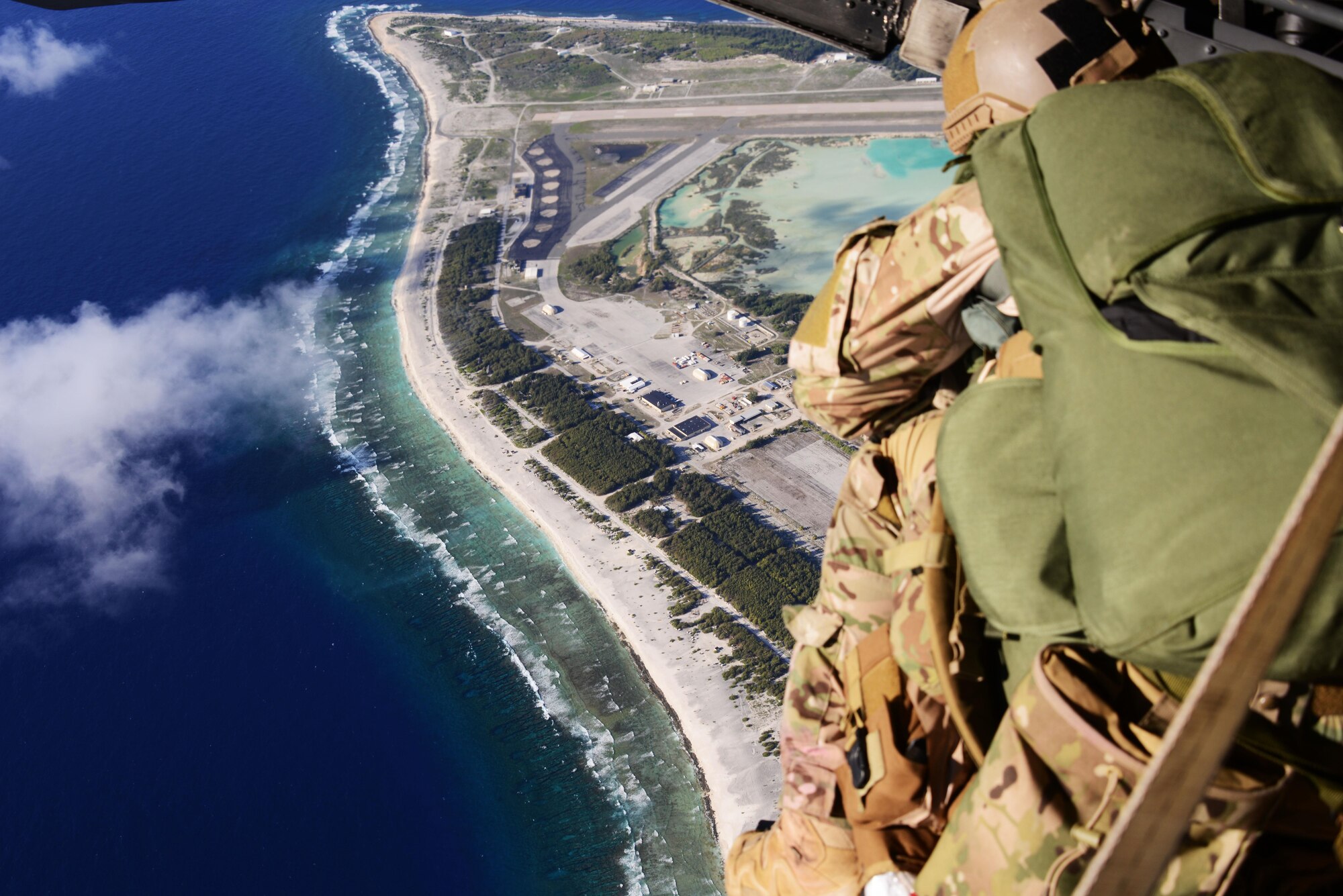 A rescue jumpmaster from the 320th Special Tactics Squadron uses rescue jumpmaster procedures to allow a special tactics team to conduct military freefall onto an unknown and unmarked drop zone.   Members from the 353rd Special Operations Group worked with the 36th Contingency Response Group from Andersen Air Base, Guam, to open Wake Island air field after Typhoon Halola passed through the island. (U.S. Air Force photo by Tech. Sgt. Kristine Dreyer) 