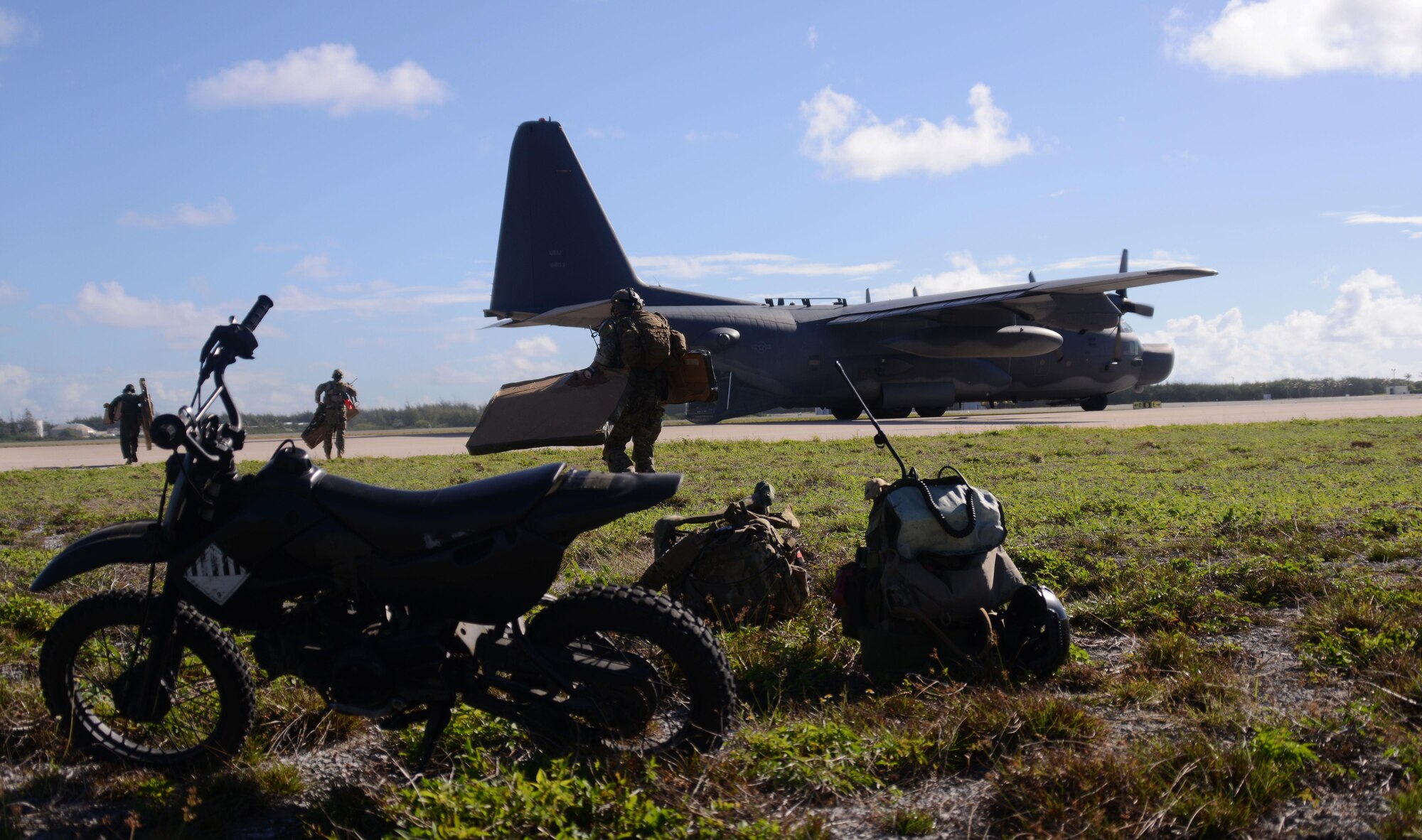 A special tactics team from the 320th Special Tactics Squadron unloads equipment from an MC-130H Combat Talon II on Wake Island July 20, 2015. After conducting military freefall operations onto the unmarked drop zone, the operators were able to clear the runway and receive the first aircraft within 20 minutes.   Members from the 353rd Special Operations Group worked with the 36th Contingency Response Group from Andersen Air Base, Guam, to open Wake Island air field after Typhoon Halola passed through the island. (U.S. Air Force photo  by Tech. Sgt. Kristine Dreyer)