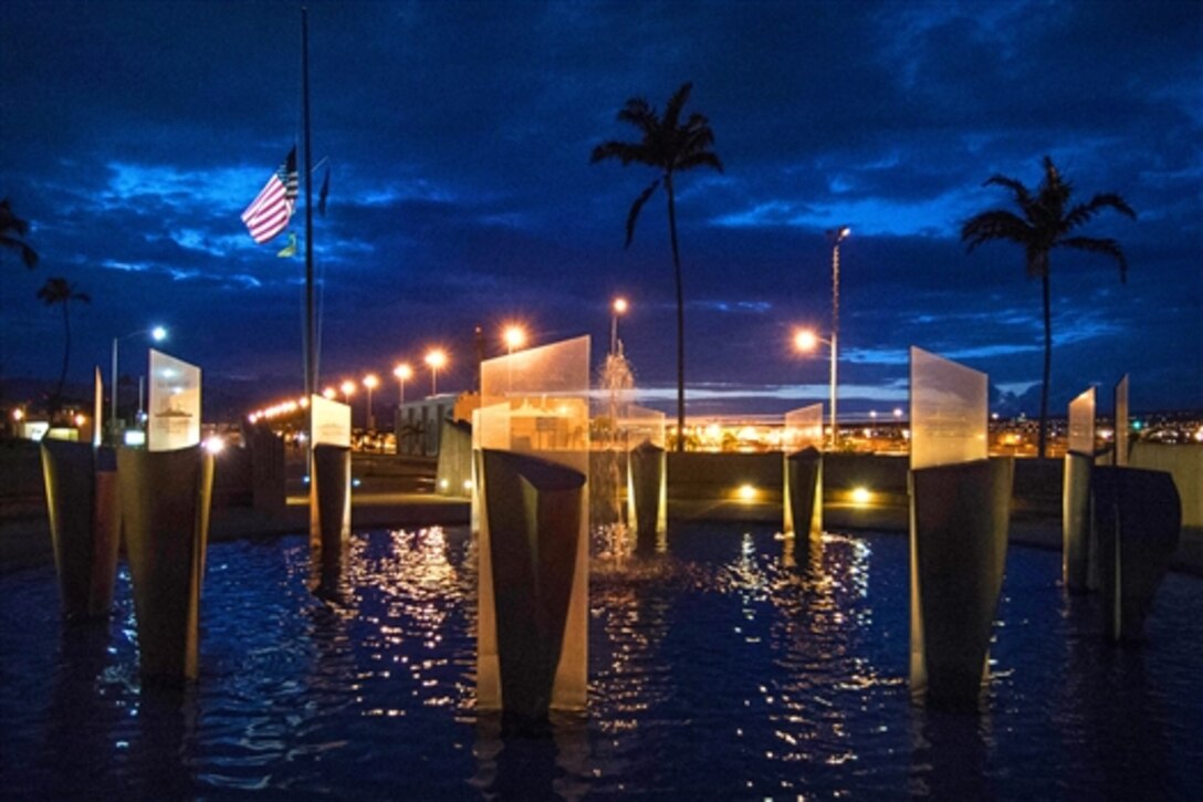 The U.S. flag, or ensign, flies at half-mast on Joint Base Pearl Harbor-Hickam, July 21, 2015. The flag will remain half-mast for five consecutive days to honor the life of each service member killed by a gunman in Chattanooga.