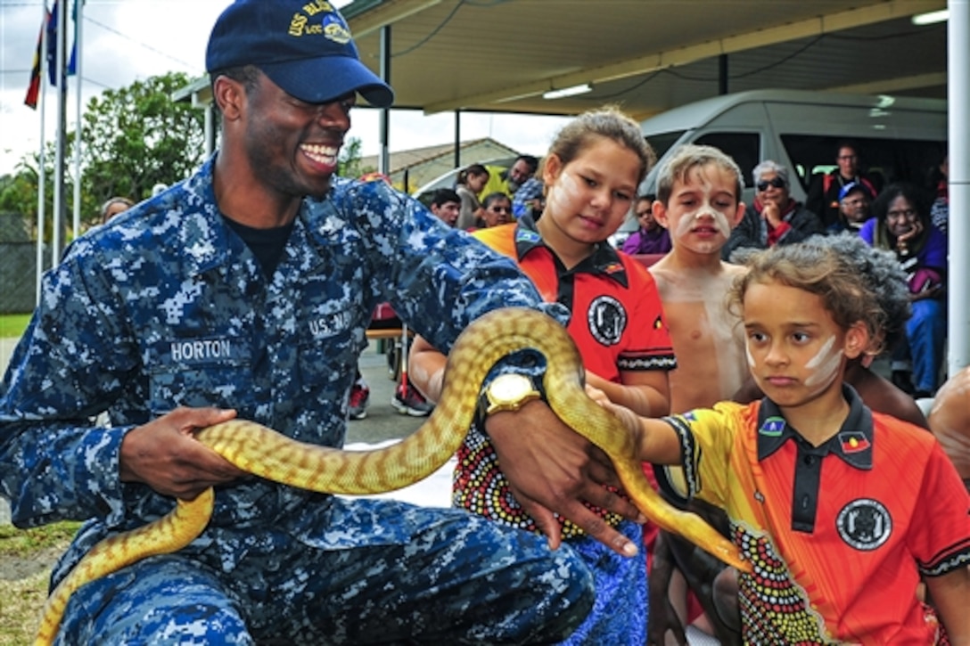 U.S. Petty Officer 3rd Class Dearra Horton holds a snake to show students from the Aboriginal and Islander Independent Community School during a community service event at Burringilly Aboriginal Corporation in Brisbane, Australia, July 21, 2015. Horton is a culinary specialist assigned to the USS Blue Ridge, which is visiting Brisbane while patrolling the 7th Fleet area of operations. 