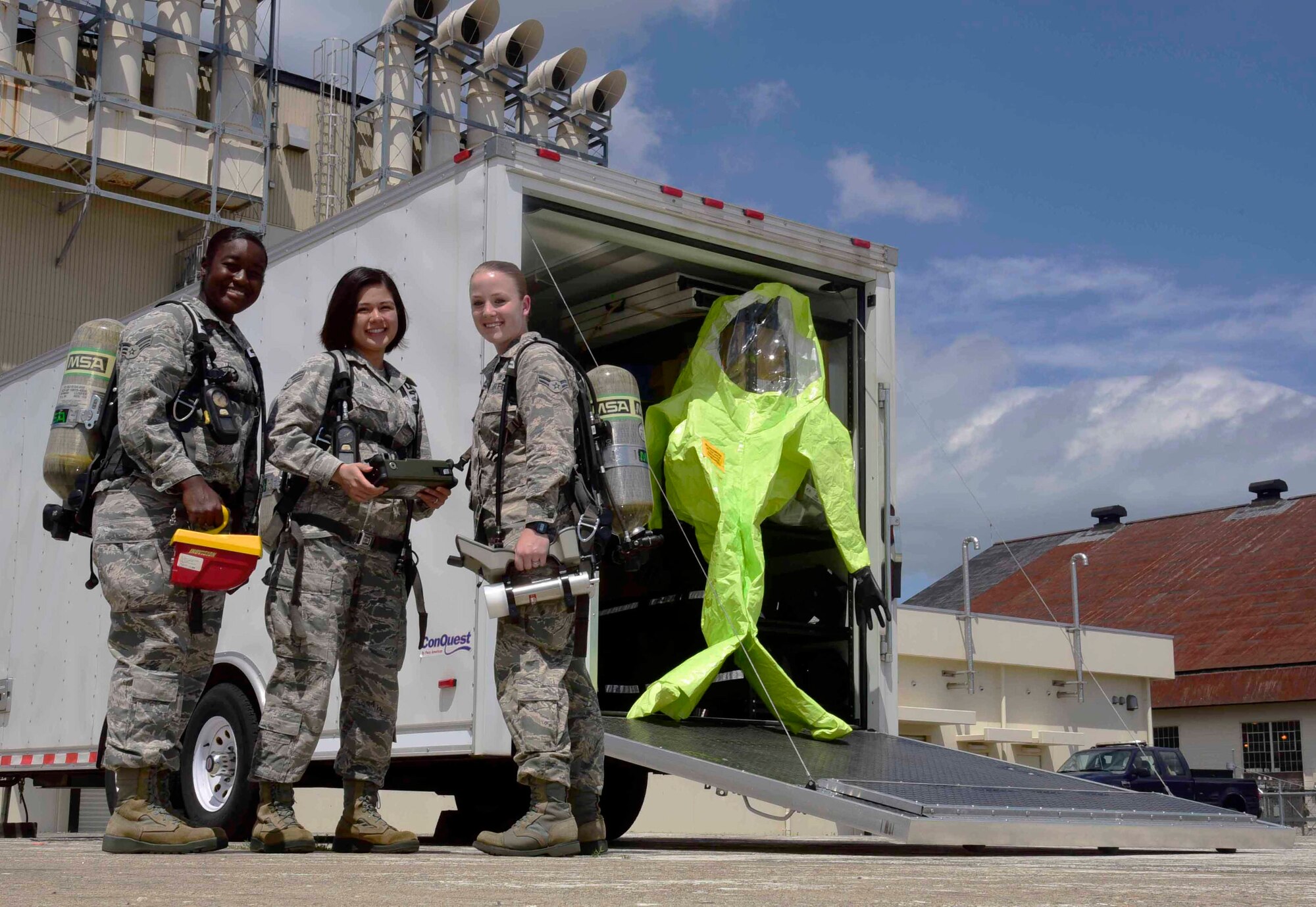 U.S. Air Force Senior Airmen Bethany Hill and Zenny Dinh, and Airman 1st Class Ann Keyser, 35th Aerospace Medicine Squadron bioenvironmental engineer journeymen, pose in front of their supply trailer at Misawa Air Base, Japan, July 22, 2015. The trio represent three of the four 35 AMDS Airmen selected for below-the-zone promotion from January 2014 to June 2015. (U.S. Air Force photo by Airman 1st Class Jordyn Fetter/Released) 