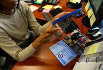 Staff Sgt. Anastasia Miller, Airman Dorm Leader, unwraps a new release requested by the Airmen living in the dormitory housing July 23, 2015, at Malmstrom AFB, Mont. Airmen are welcomed and encouraged to hang out in the CDMO office to watch movies on the office TV during their free time. (U.S. Air Force photo/Airman 1st Class Magen M. Reeves) 
