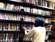 Staff Sgt. Anastasia Miller, Airman Dorm Leader, adds new releases to the Central Dorm Management Office movie library July 23, 2015, at Malmstrom AFB, Mont. CDMO rents movies free to Airmen living in the dormitory housing. (U.S. Air Force photo/Airman 1st Class Magen M. Reeves)