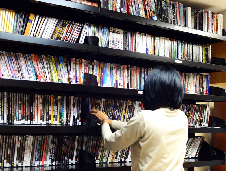 Staff Sgt. Anastasia Miller, Airman Dorm Leader, adds new releases to the Central Dorm Management Office movie library July 23, 2015, at Malmstrom AFB, Mont. CDMO rents movies free to Airmen living in the dormitory housing. (U.S. Air Force photo/Airman 1st Class Magen M. Reeves)