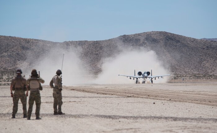 Airmen assigned to the 22nd Special Tactics Squadron, Joint Base Lewis-McChord, Wash., look on as an A-10 Thunderbolt II departs from the National Training Center at Fort Irwin, Calif., July 16, 2015. An austere field landing allows for the A-10 pilots to push in, refuel, and provide support in a heavily-contested environment. (U.S. Air Force photo by Airman 1st Class Mikaley Towle)
