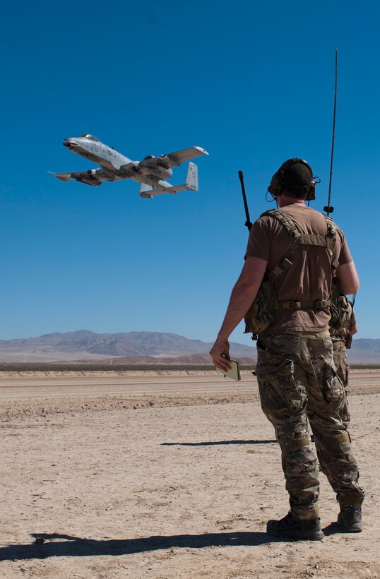 An Airman assigned to the 22nd Special Tactics Squadron, Joint Base Lewis-McChord, Wash., observes as an A-10 Thunderbolt II circle before landing in support of Green Flag West 15-08.5 on the National Training Center range at Fort Irwin, Calif., July 16, 2015. This marked the first time an A-10 landed on the range. (U.S. Air Force photo by Airman 1st Class Mikaley Towle)